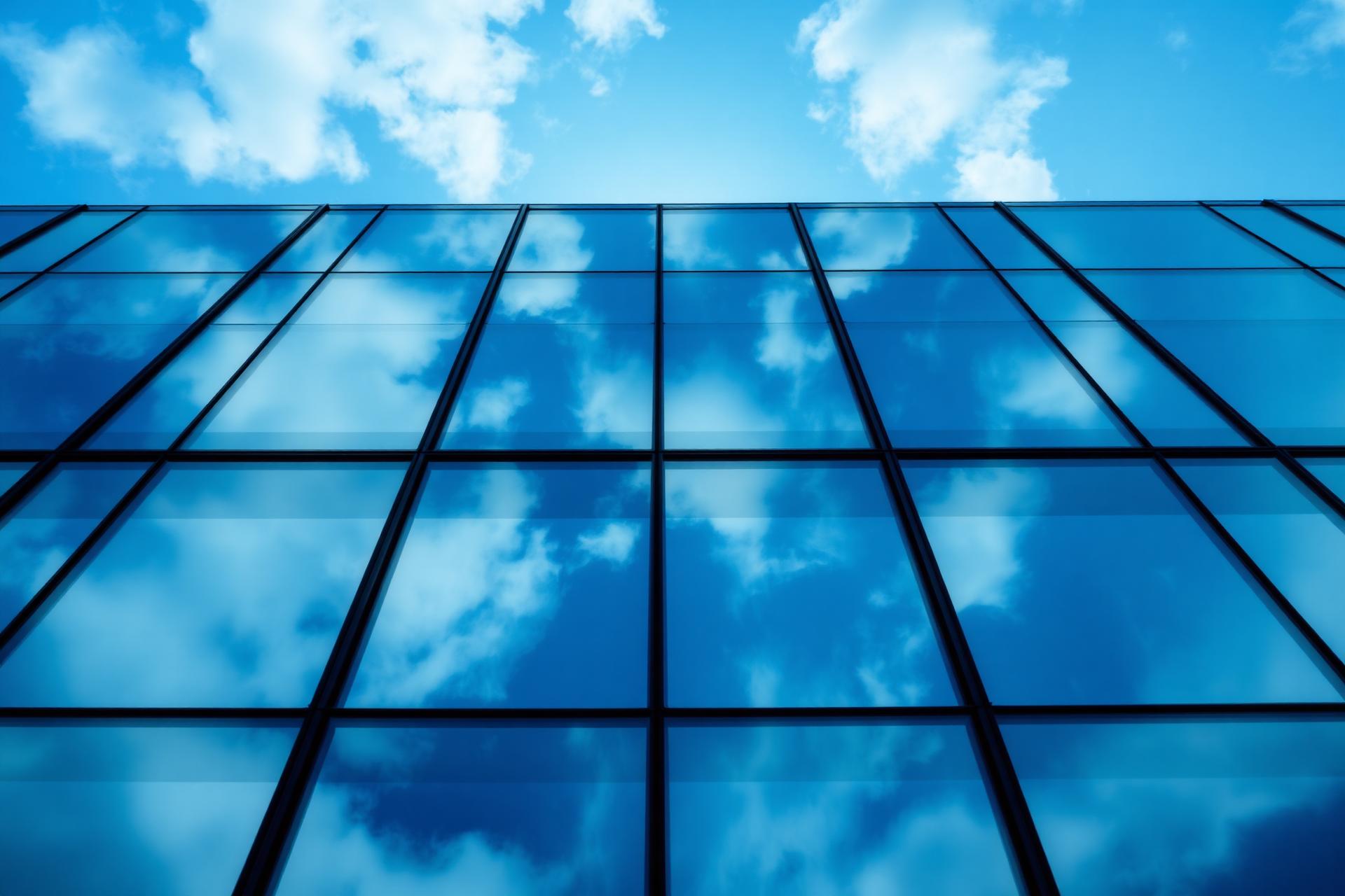 Modern glass façade reflecting the sky